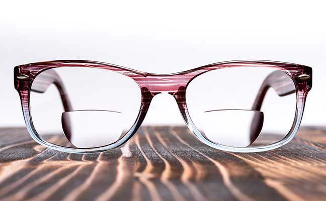 bifocal lenses glasses on a wood board